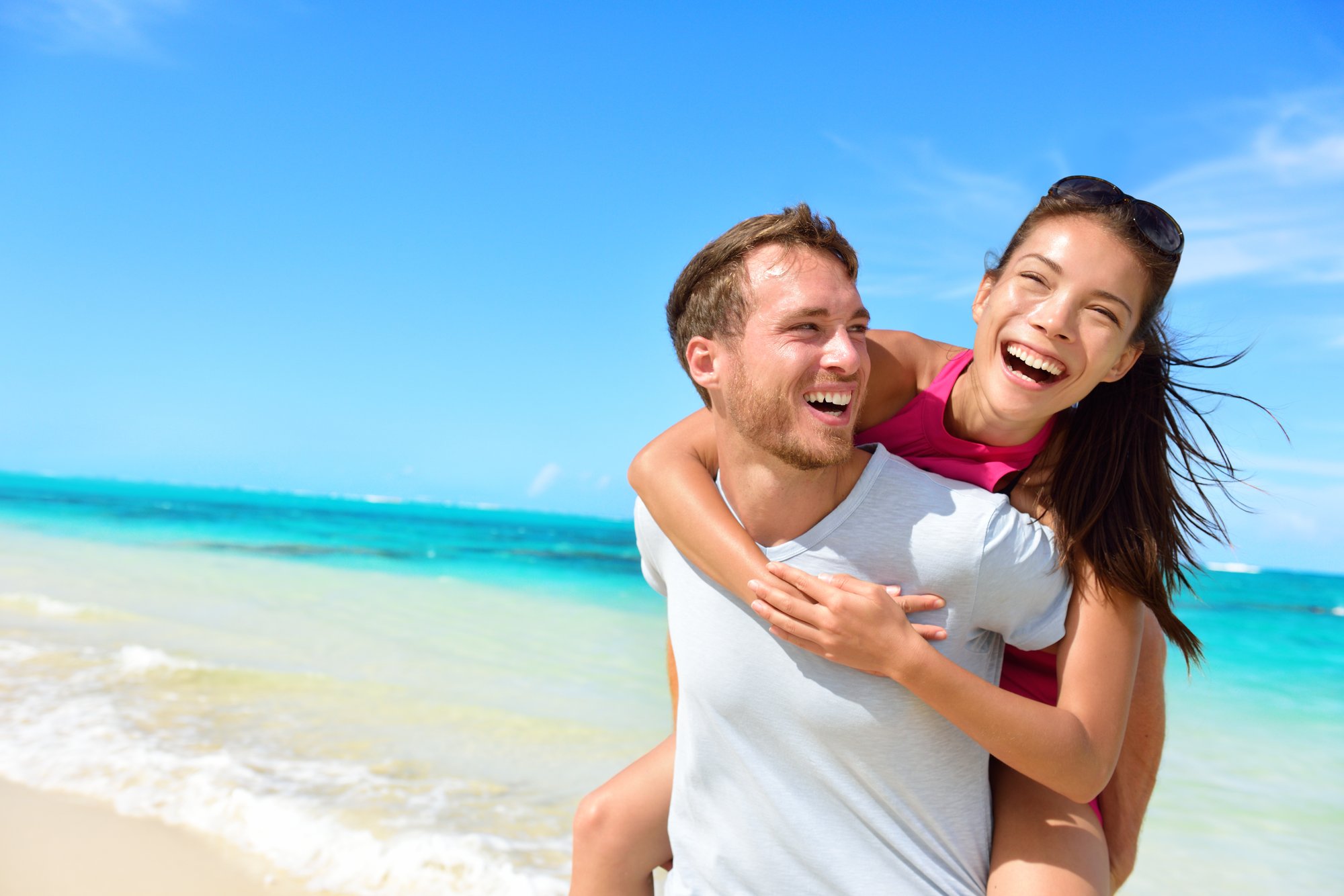 bigstock-Happy-couple-in-love-on-beach--85188443